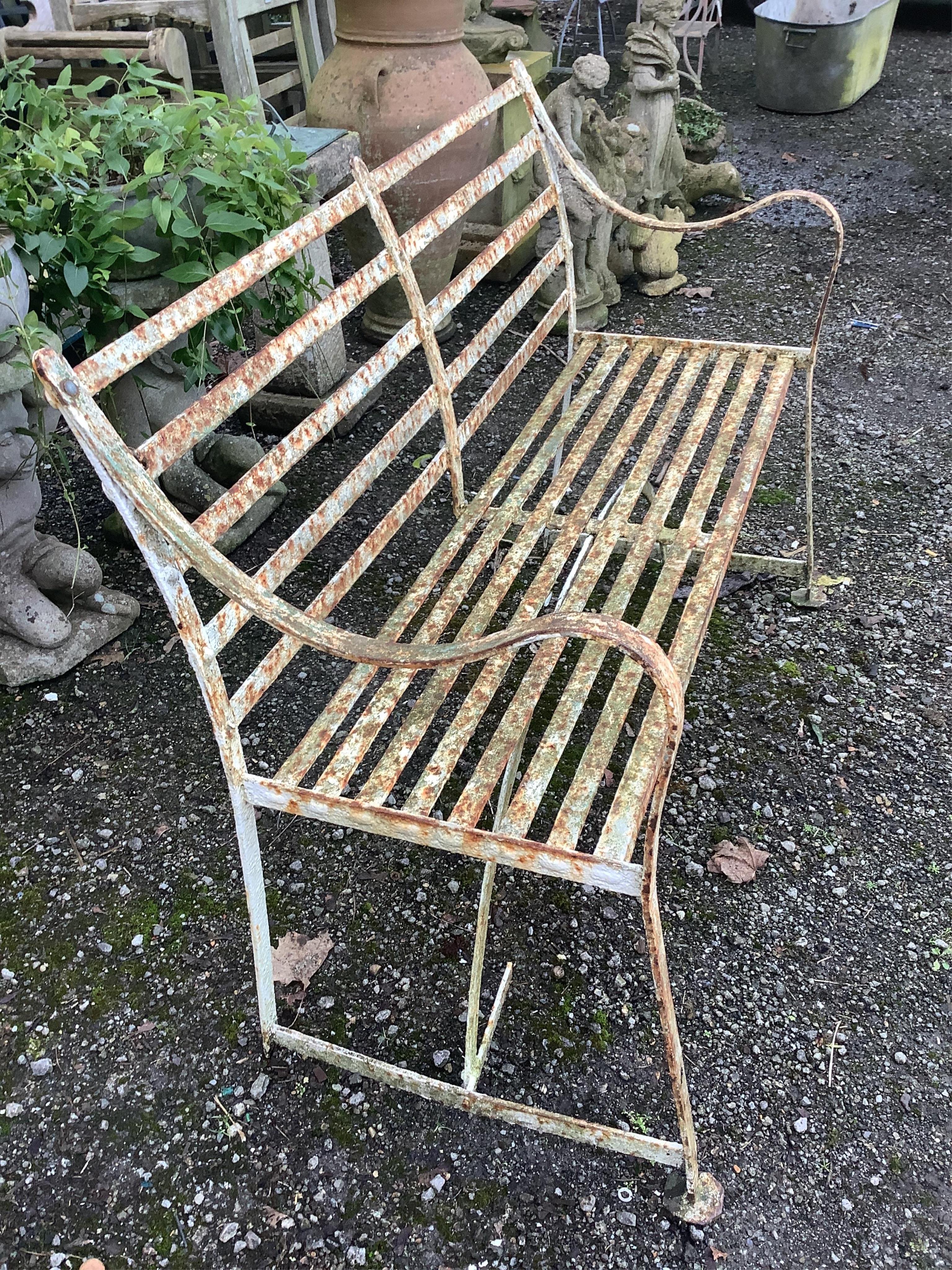 A 19th century white painted slatted wrought iron garden bench, width 122cm, depth 45cm, height 88cm. Condition - poor to fair